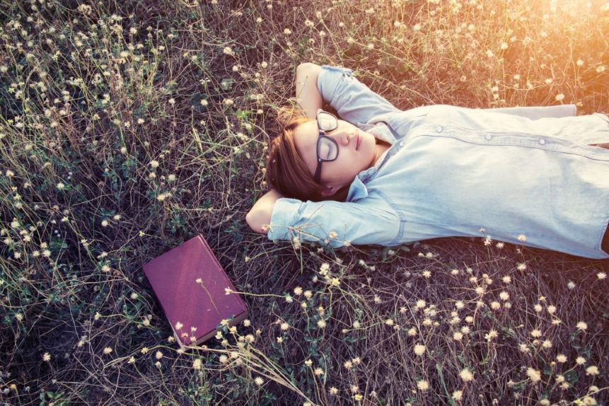 A woman resting peacefully with a Bible beside her.