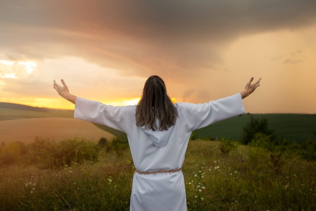 Christ welcoming the light of the sun over him.