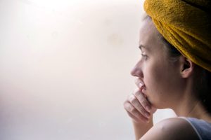 A woman peering outside, doubting nothing is too hard
