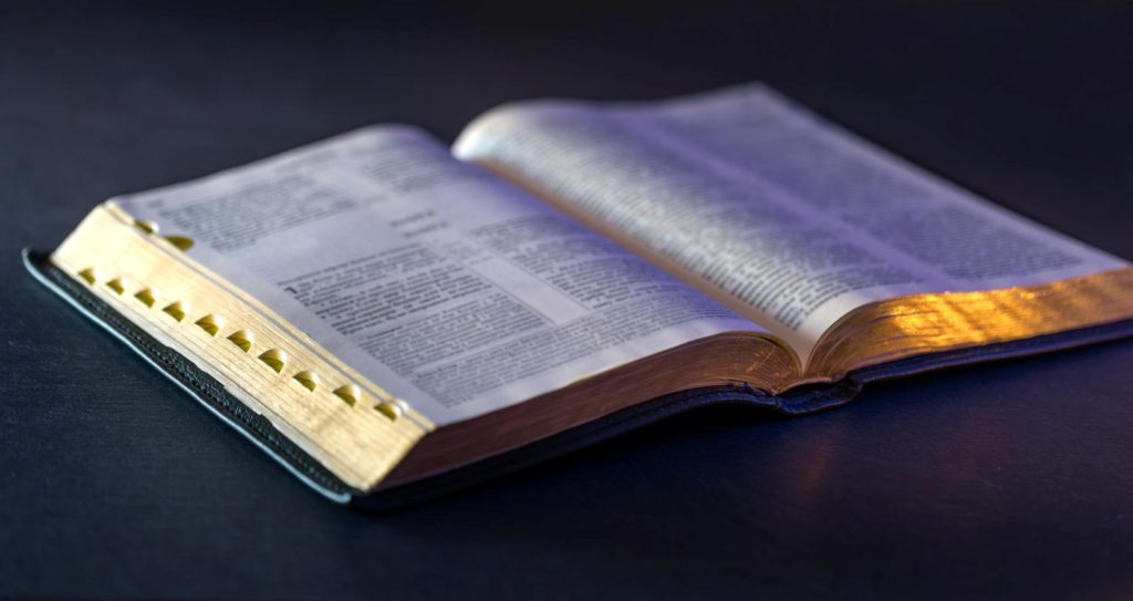A Bible opened over a table.